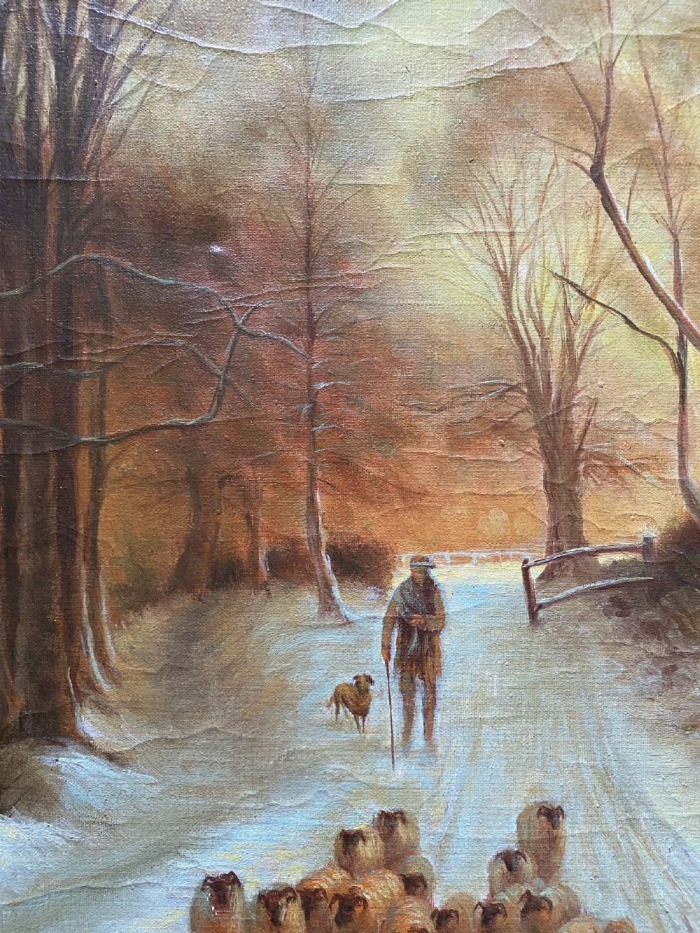 A framed oil painting depicting a shepherd droving a flock of sheep along a snow-covered forest track at sunset. View IX