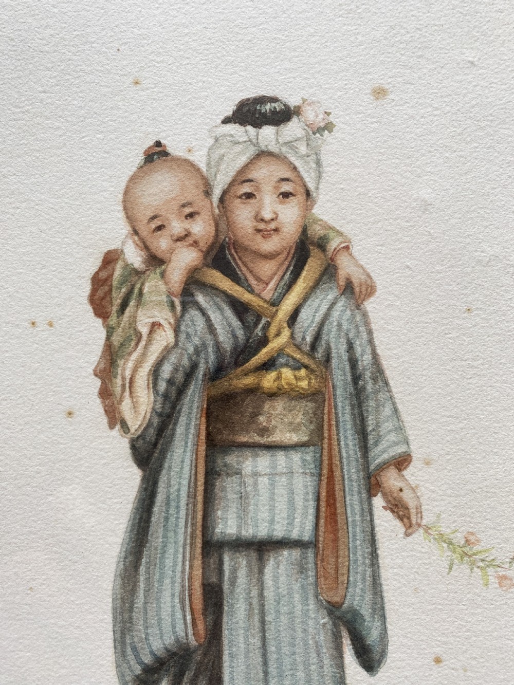 A framed triptych of three watercolour paintings by Takashi Nakayama depicting Japanese figures in traditional attire, including a fisherman, a mother carrying a child, and a labourer with a basket. View VI