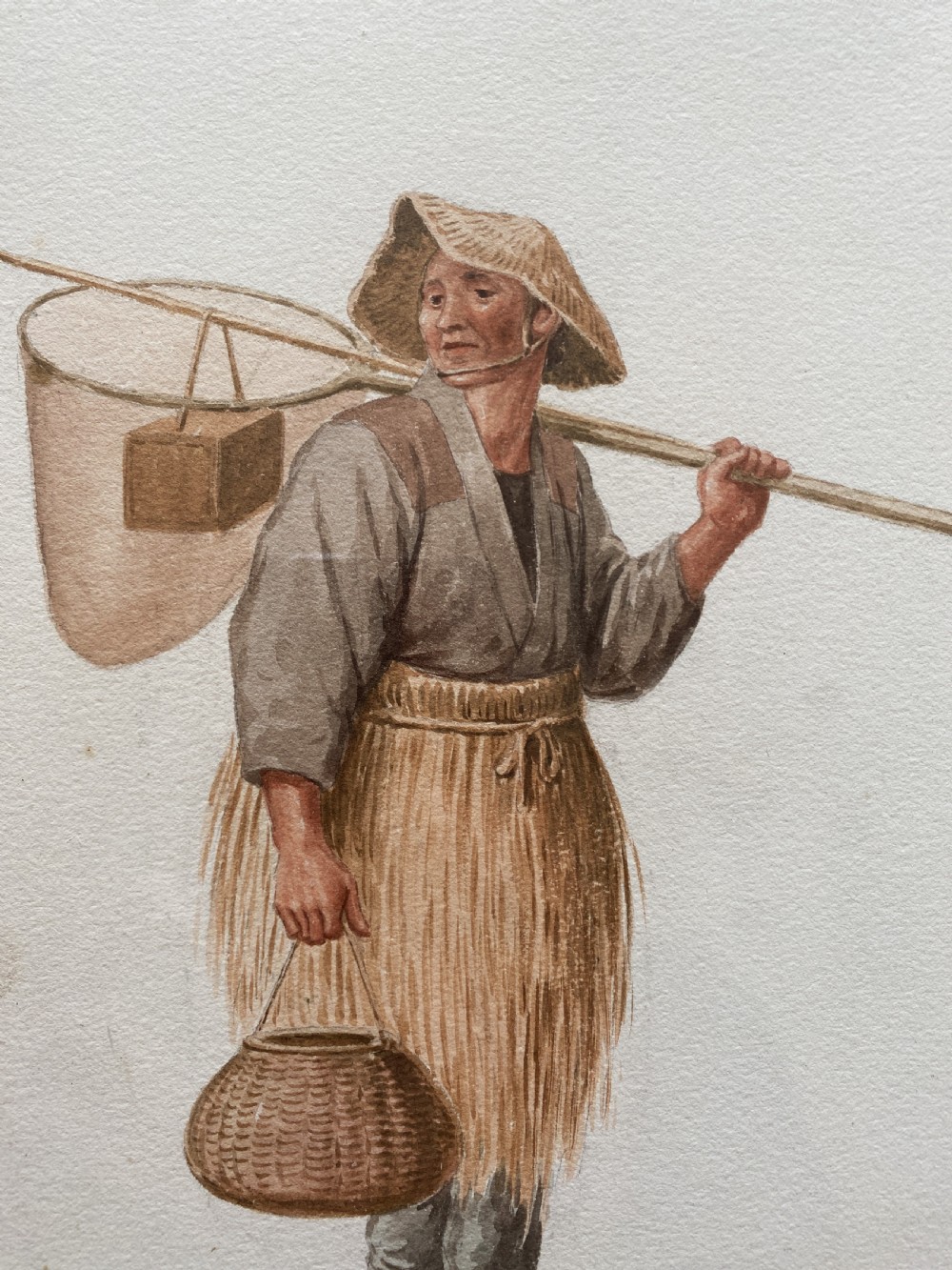 A framed triptych of three watercolour paintings by Takashi Nakayama depicting Japanese figures in traditional attire, including a fisherman, a mother carrying a child, and a labourer with a basket. View VIII