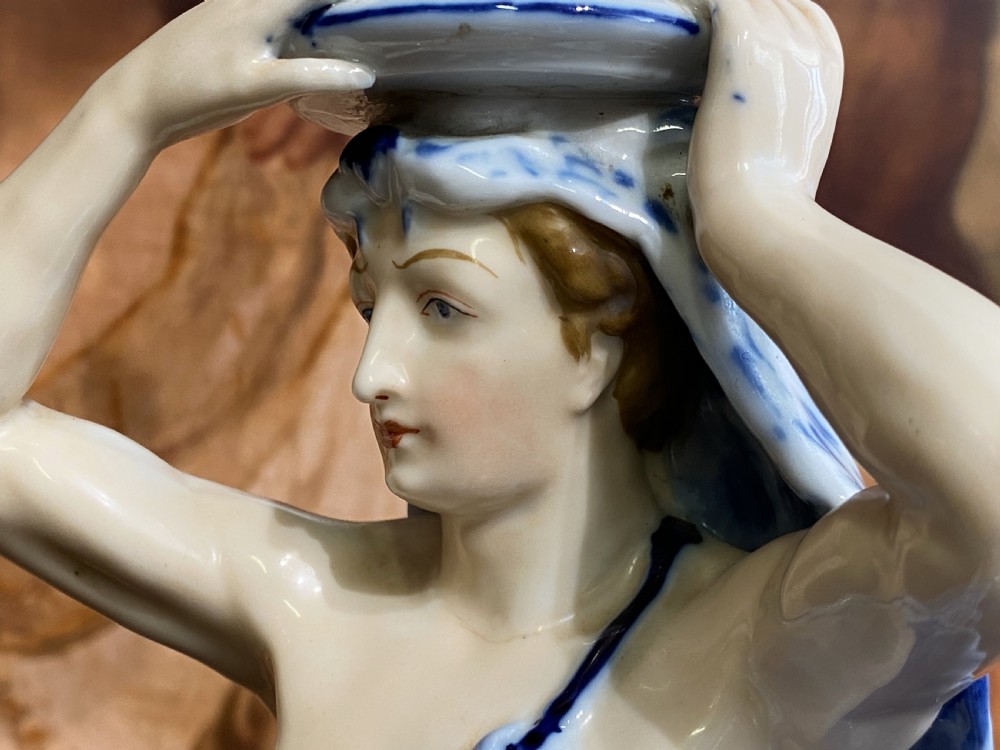 An Art Deco blue and white porcelain table lamp featuring a sculpted male figure on a decorative pedestal with a twin brass light socket stem. View XIV