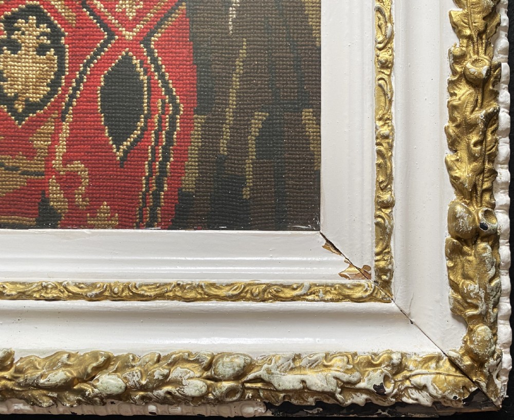 A framed mid-nineteenth-century Berlin woolwork tapestry depicting four historical figures seated around a carpet-covered table, housed within a gilt decorative frame. View VIII