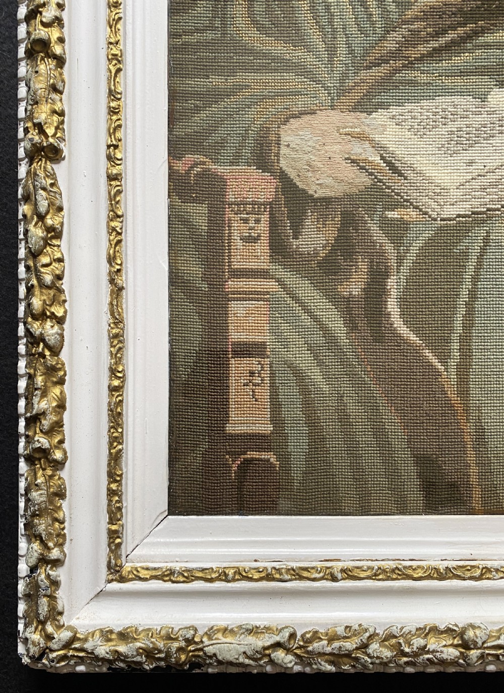 A framed mid-nineteenth-century Berlin woolwork tapestry depicting four historical figures seated around a carpet-covered table, housed within a gilt decorative frame. View IX