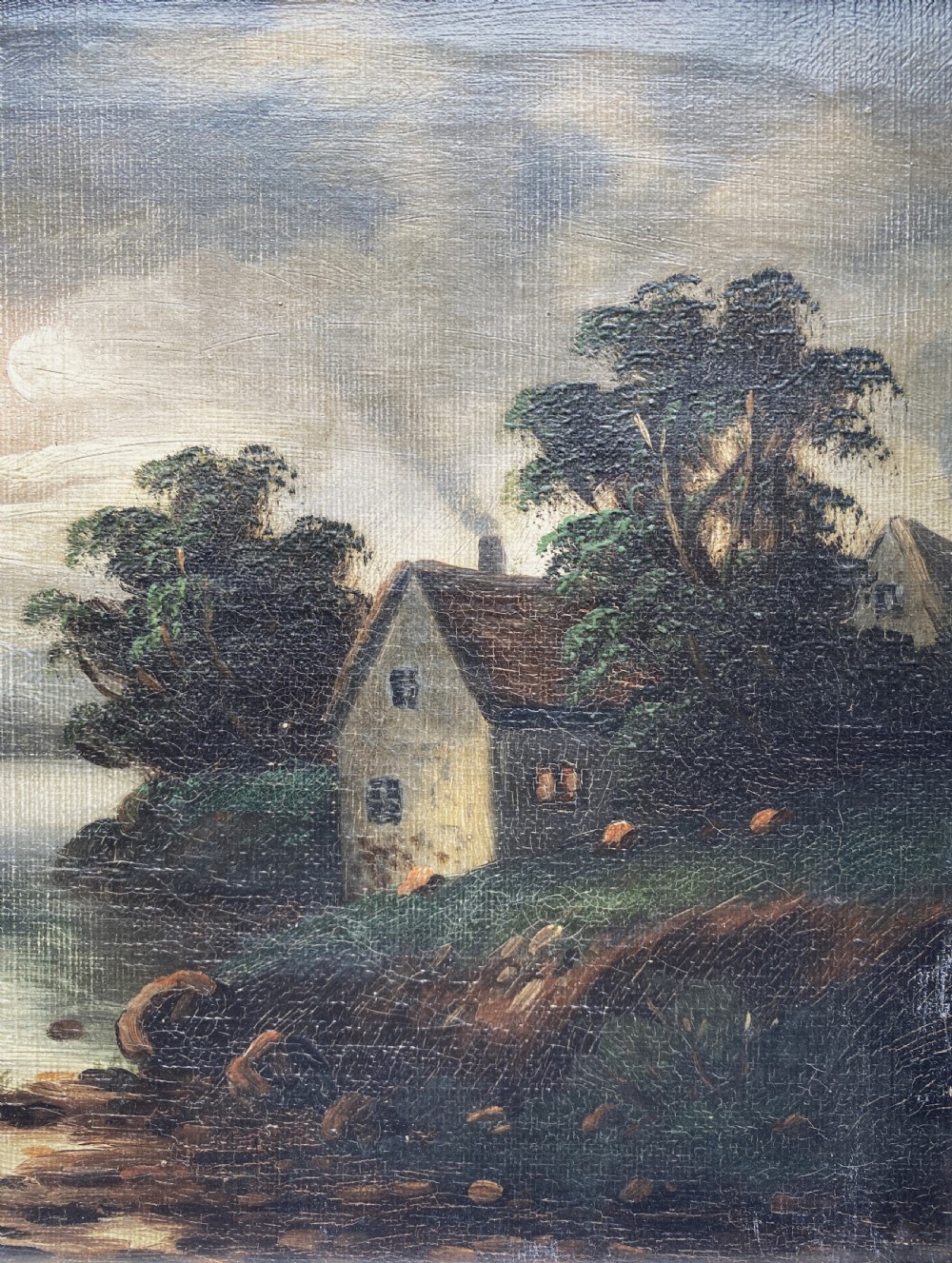 An oil painting depicting a moonlit highland loch scene with a small cottage near the water, framed in a thick white painted wooden frame. View IV