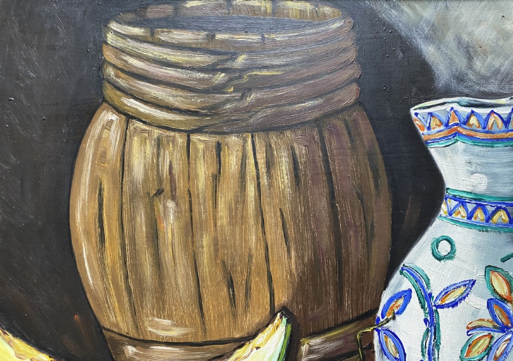 A framed mid-century oil painting depicting a still life composition with a blue patterned ceramic jug, a wooden barrel, a melon slice, and purple grapes. View VII