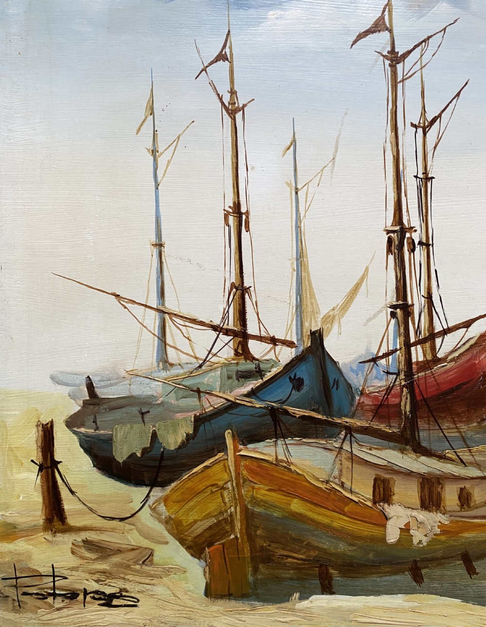 A horizontal mid-century oil painting depicting grounded fishing vessels on a sandy harbour floor beneath a cloudy blue sky, contained within a textured brown frame. View VI