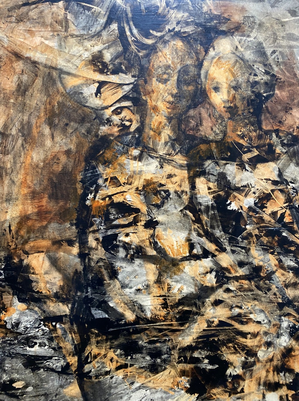 A vertical abstract acrylic painting of layered human figures in earth tones, framed by a linen slip and a tiered gold gilt moulding. View V