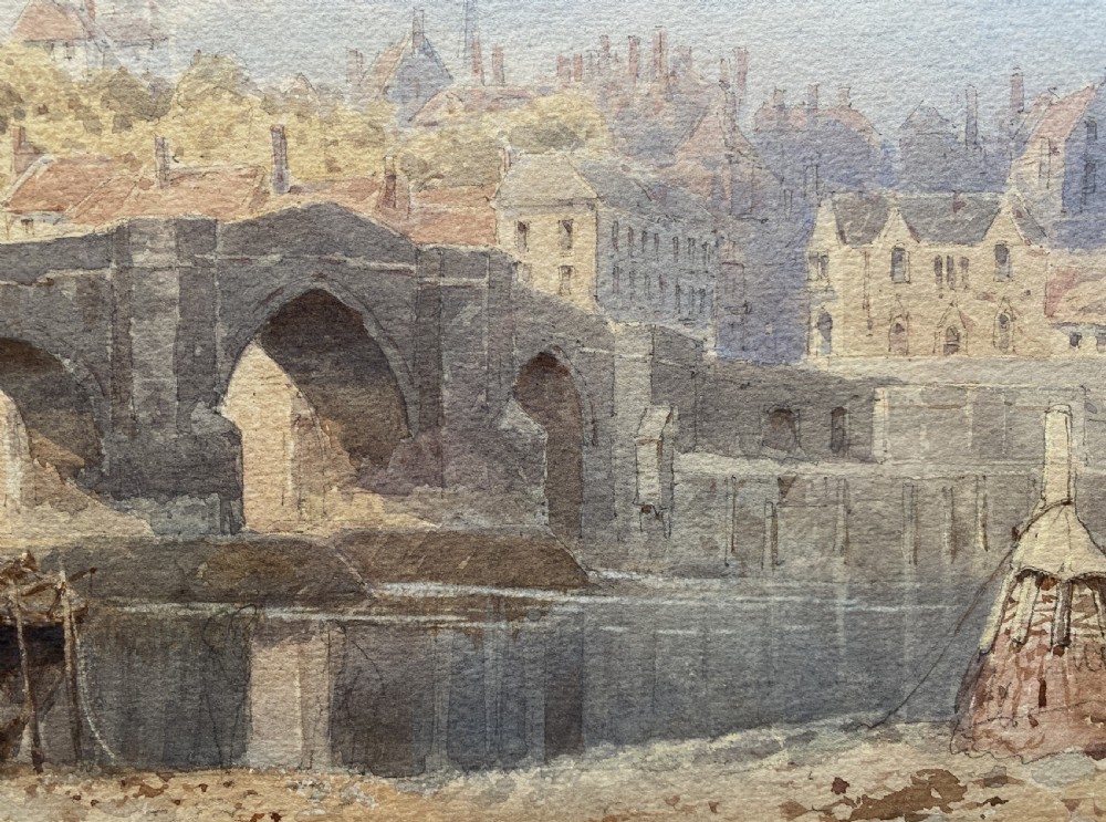 A framed 19th-century watercolour painting depicting a river and stone arch bridge in Hereford with a skyline, set within a gilded frame and cream mount. View X