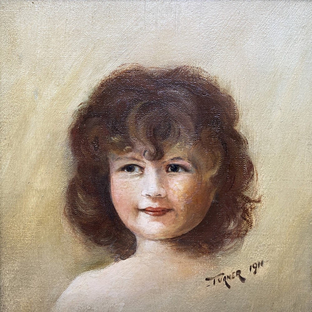 An early twentieth-century oil painting depicting a young girl with brown curly hair, framed within a wide moulded gold gilt frame. View IV