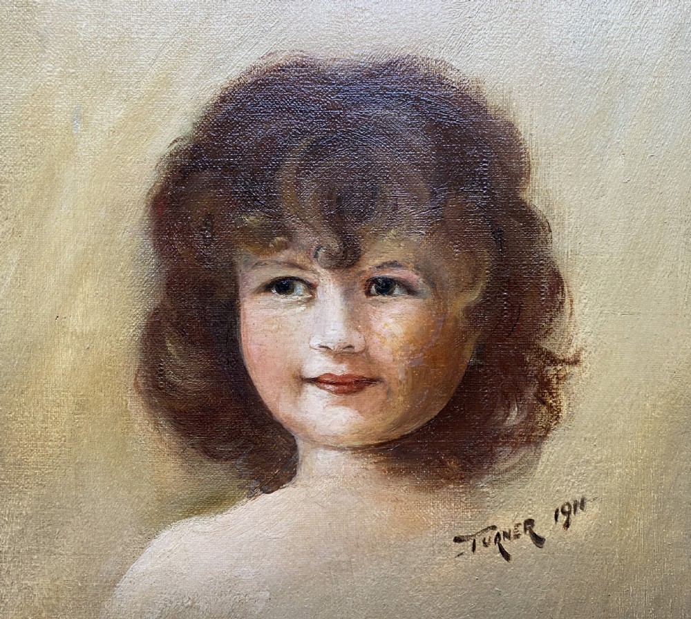 An early twentieth-century oil painting depicting a young girl with brown curly hair, framed within a wide moulded gold gilt frame. View V