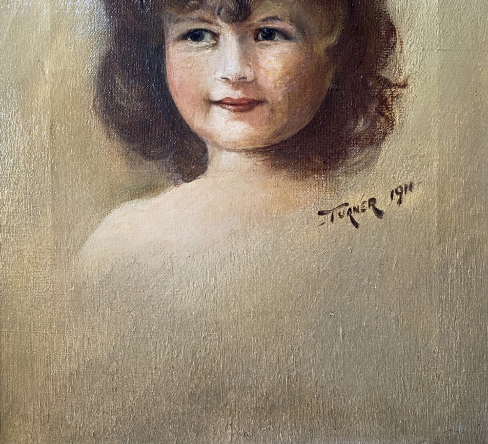 An early twentieth-century oil painting depicting a young girl with brown curly hair, framed within a wide moulded gold gilt frame. View VIII