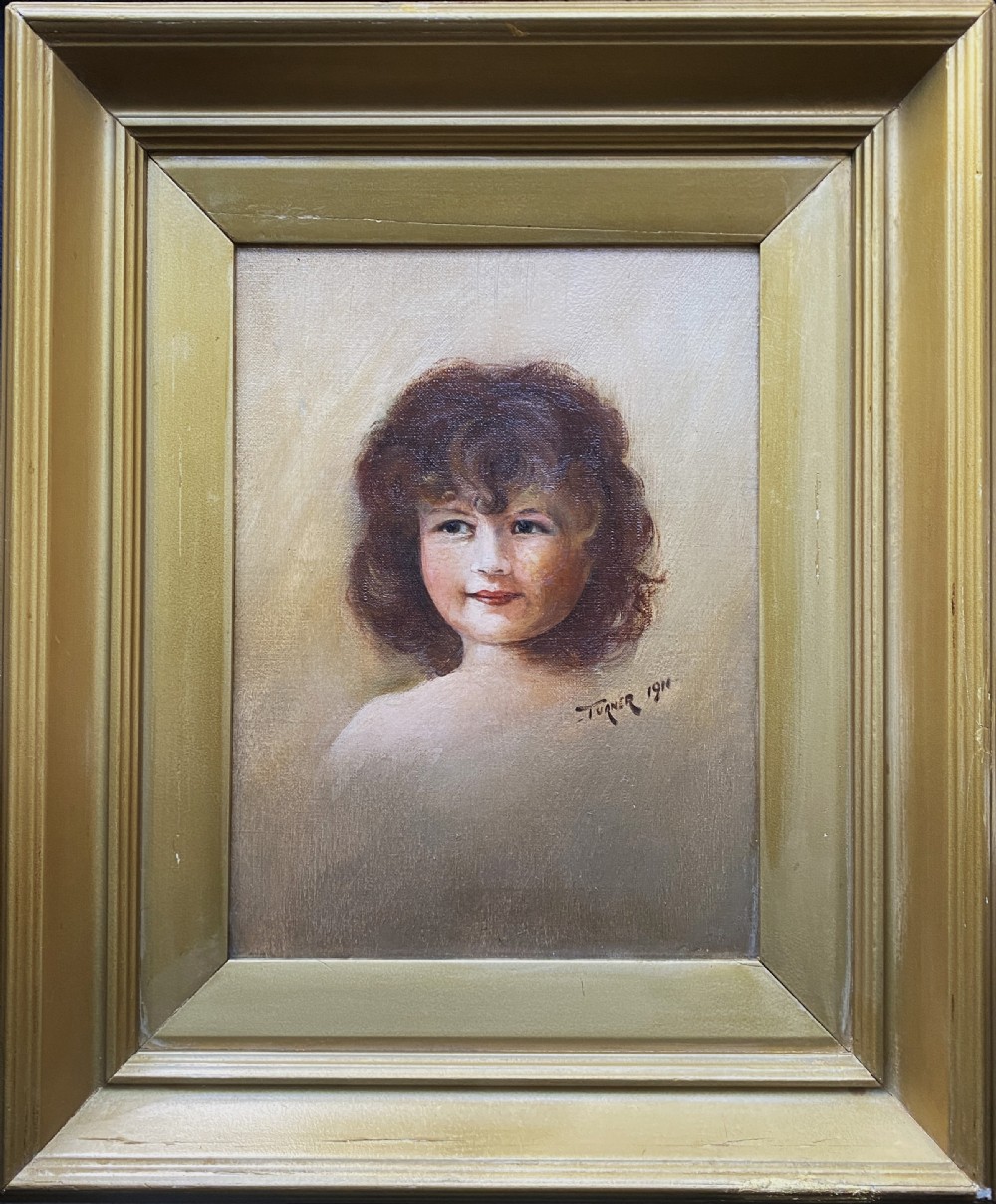 An early twentieth-century oil painting depicting a young girl with brown curly hair, framed within a wide moulded gold gilt frame. View XI