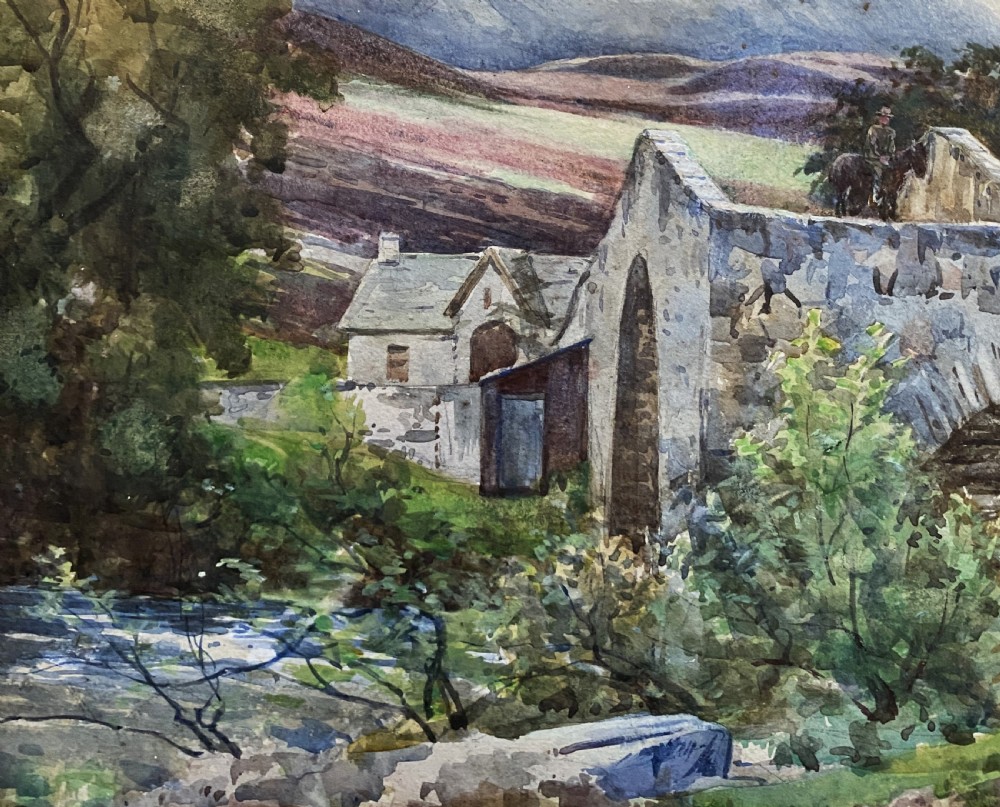 An early 20th-century watercolour painting depicting a stone arch bridge over a river surrounded by hills, set within a wide gold frame. View VI