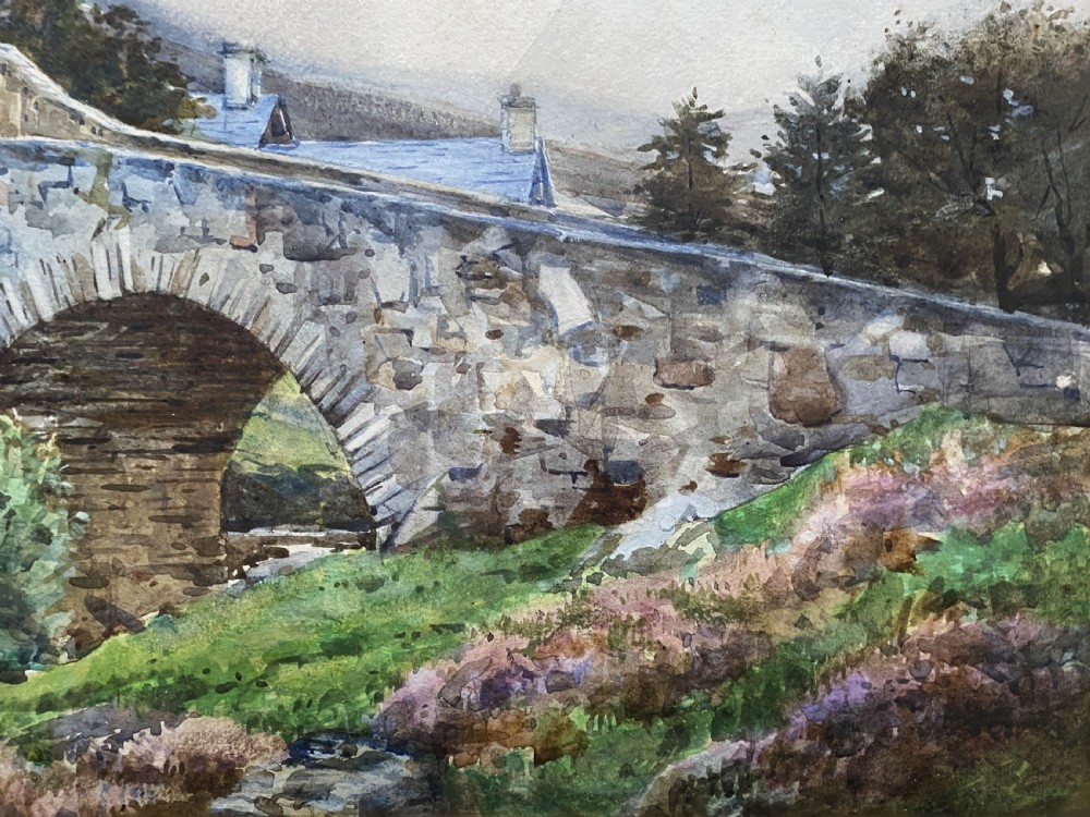 An early 20th-century watercolour painting depicting a stone arch bridge over a river surrounded by hills, set within a wide gold frame. View VIII