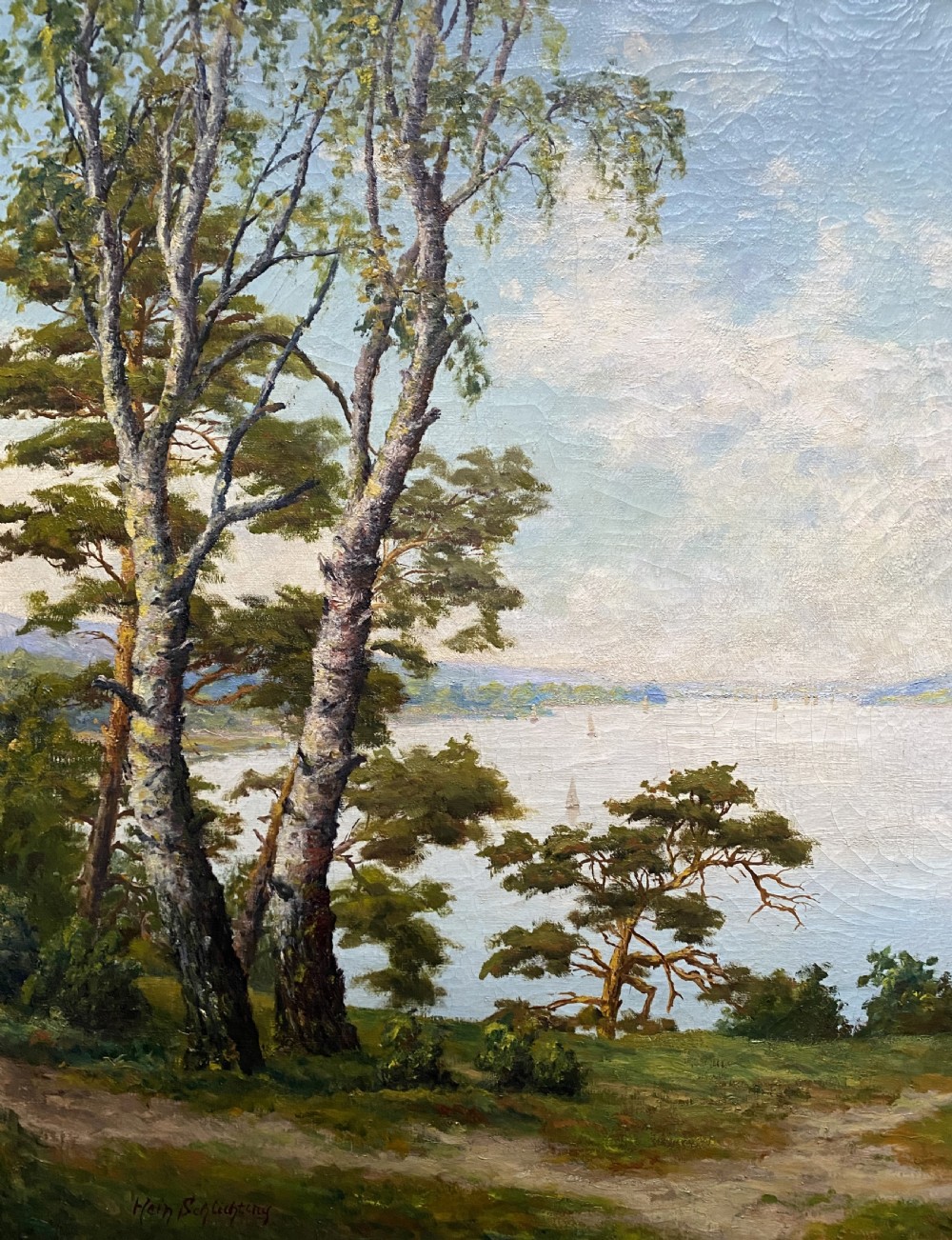 A signed 20th-century oil painting depicting a calm lake with sailboats framed by birch and pine trees in a silvered wooden frame. View V