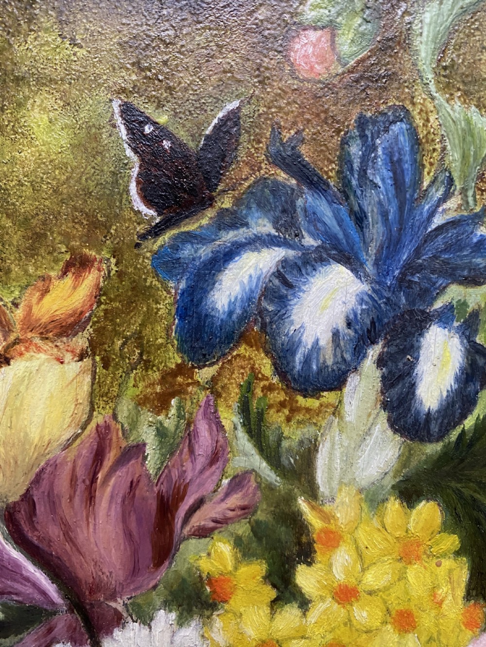 A framed oil painting featuring a floral bouquet in an urn set upon a ledge next to a bird nest. View VI