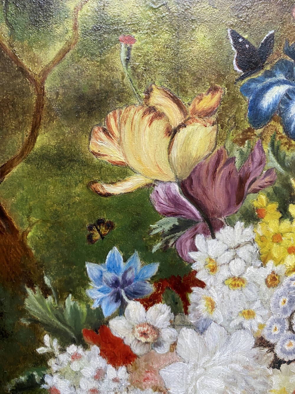 A framed oil painting featuring a floral bouquet in an urn set upon a ledge next to a bird nest. View VII