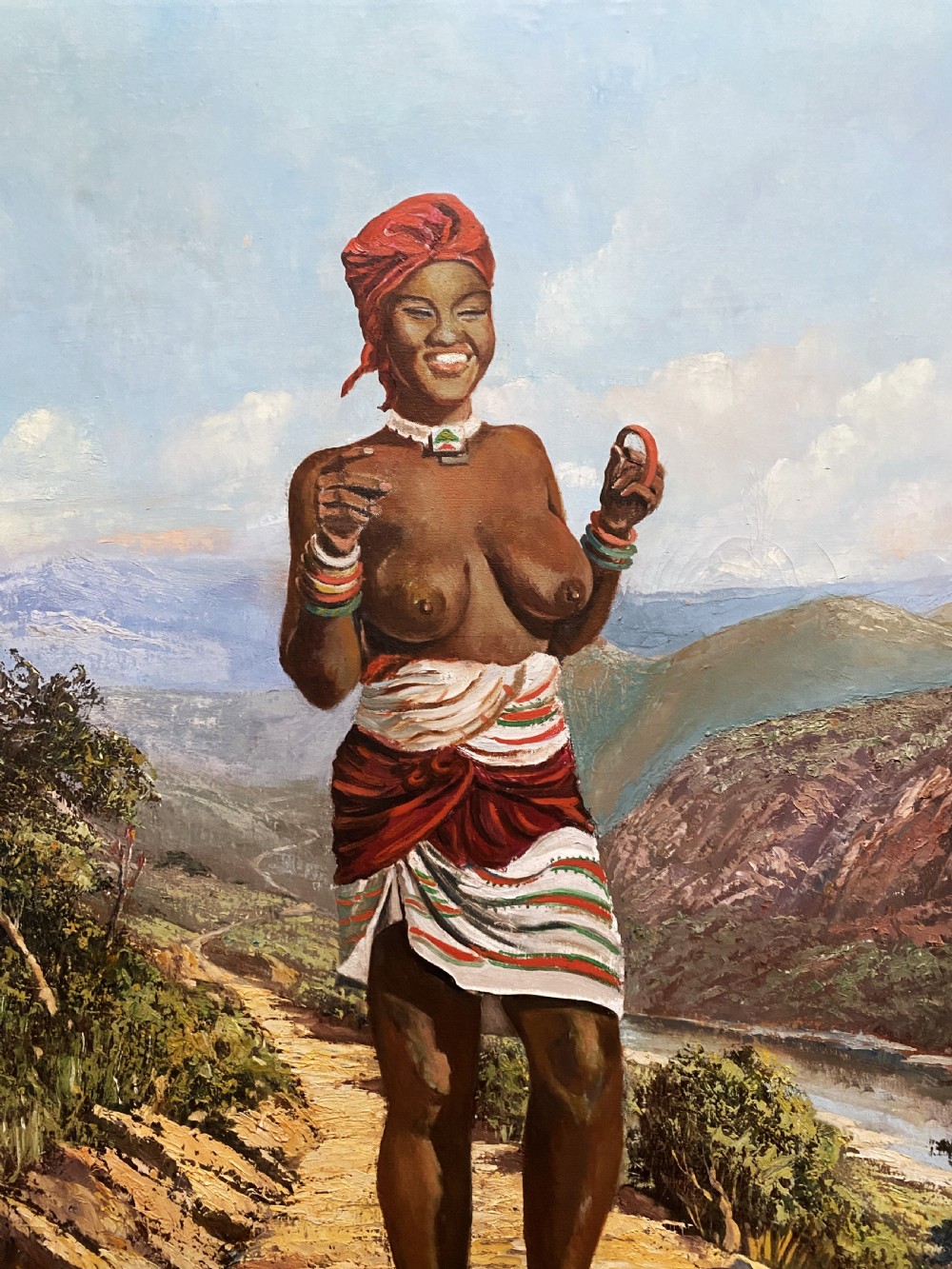 A mid-century impressionist oil painting depicting a smiling figure in traditional attire standing on a sunlit mountain path within a gold-painted frame. View V