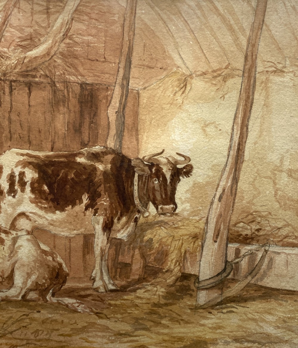 A sepia watercolour painting depicting two cows inside a timber barn, housed within a layered card mount and a burr wood frame. View IV