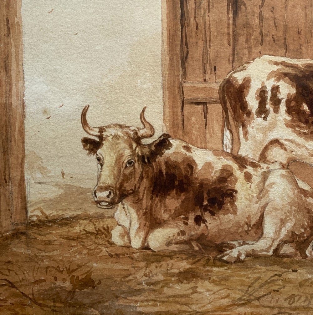 A sepia watercolour painting depicting two cows inside a timber barn, housed within a layered card mount and a burr wood frame. View V