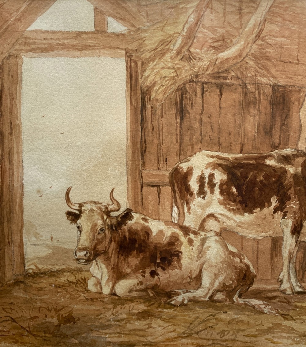 A sepia watercolour painting depicting two cows inside a timber barn, housed within a layered card mount and a burr wood frame. View VI