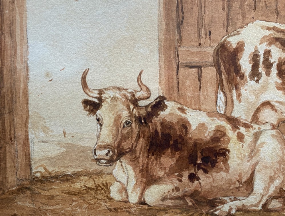 A sepia watercolour painting depicting two cows inside a timber barn, housed within a layered card mount and a burr wood frame. View IX