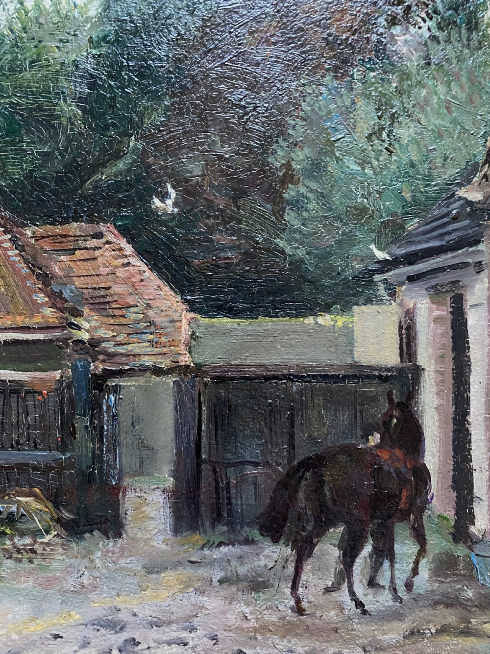 An early twentieth-century oil painting depicting a country house courtyard with figures, a dog, and a horse, set within an ornate gilt swept frame. View VIII