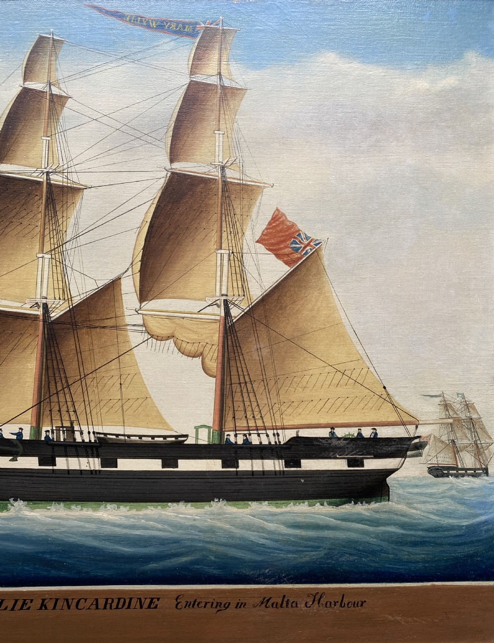 An early 19th-century marine oil painting depicting a two-masted brig ship sailing into Malta harbour, set within a black and gilt wooden frame. View IV