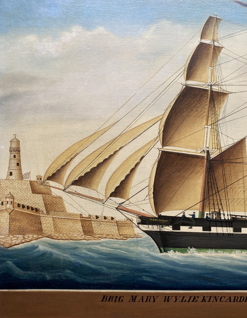 An early 19th-century marine oil painting depicting a two-masted brig ship sailing into Malta harbour, set within a black and gilt wooden frame. View IX