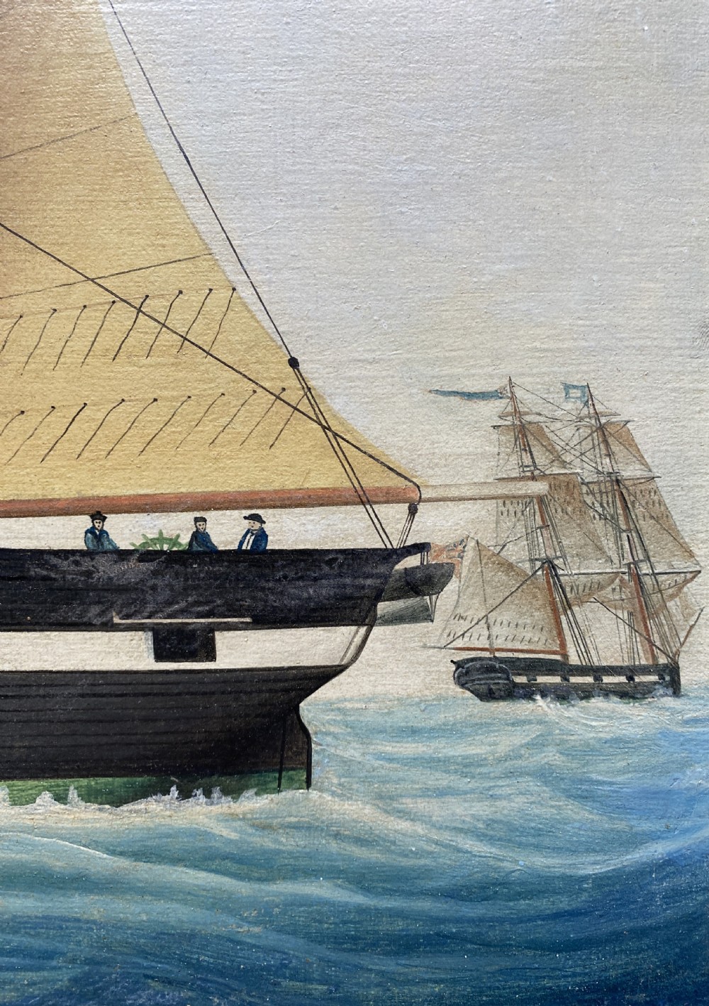 An early 19th-century marine oil painting depicting a two-masted brig ship sailing into Malta harbour, set within a black and gilt wooden frame. View XI