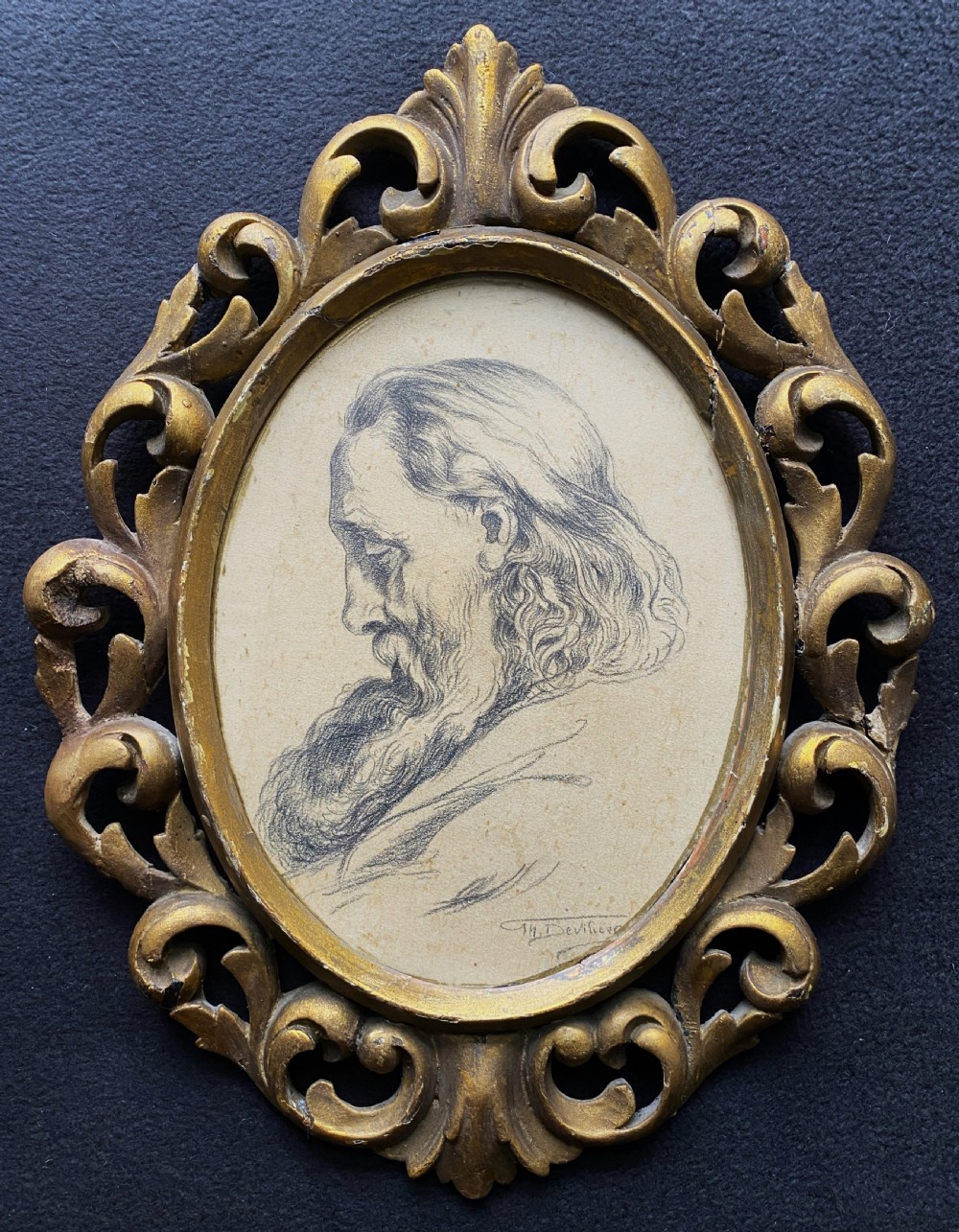 An oval charcoal profile drawing on paper depicting a bearded man with long hair, set inside a carved gold leaf Florentine frame. View II