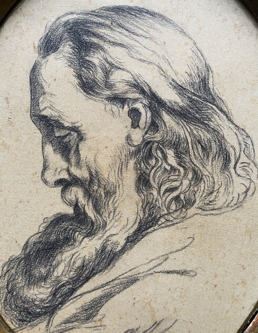 An oval charcoal profile drawing on paper depicting a bearded man with long hair, set inside a carved gold leaf Florentine frame. View VII