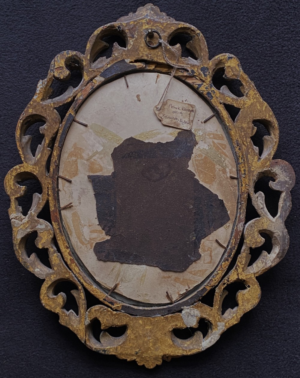An oval charcoal profile drawing on paper depicting a bearded man with long hair, set inside a carved gold leaf Florentine frame. View XII