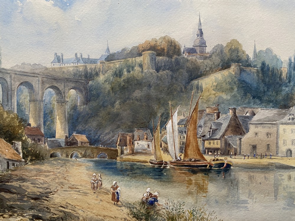 A framed 19th-century watercolour painting depicting a river scene with boats, a stone viaduct, and a hillside town set within an ornate gilded frame. View III