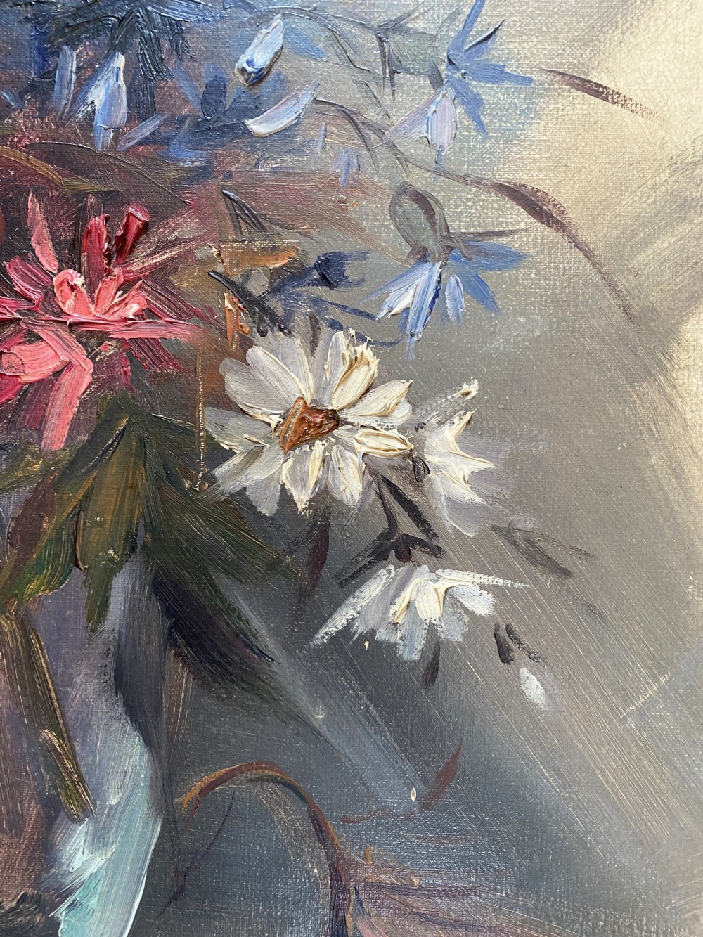 A mid-century oil painting on canvas depicting pink and blue flowers in a glass vase, displayed inside an ornate gold gilded frame. View IX