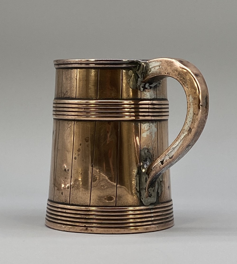 A tapered late Georgian copper tankard featuring horizontal reeded bands, vertical staved lines, and a curved nickel-plated handle. View III