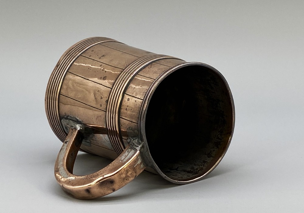 A tapered late Georgian copper tankard featuring horizontal reeded bands, vertical staved lines, and a curved nickel-plated handle. View VIII