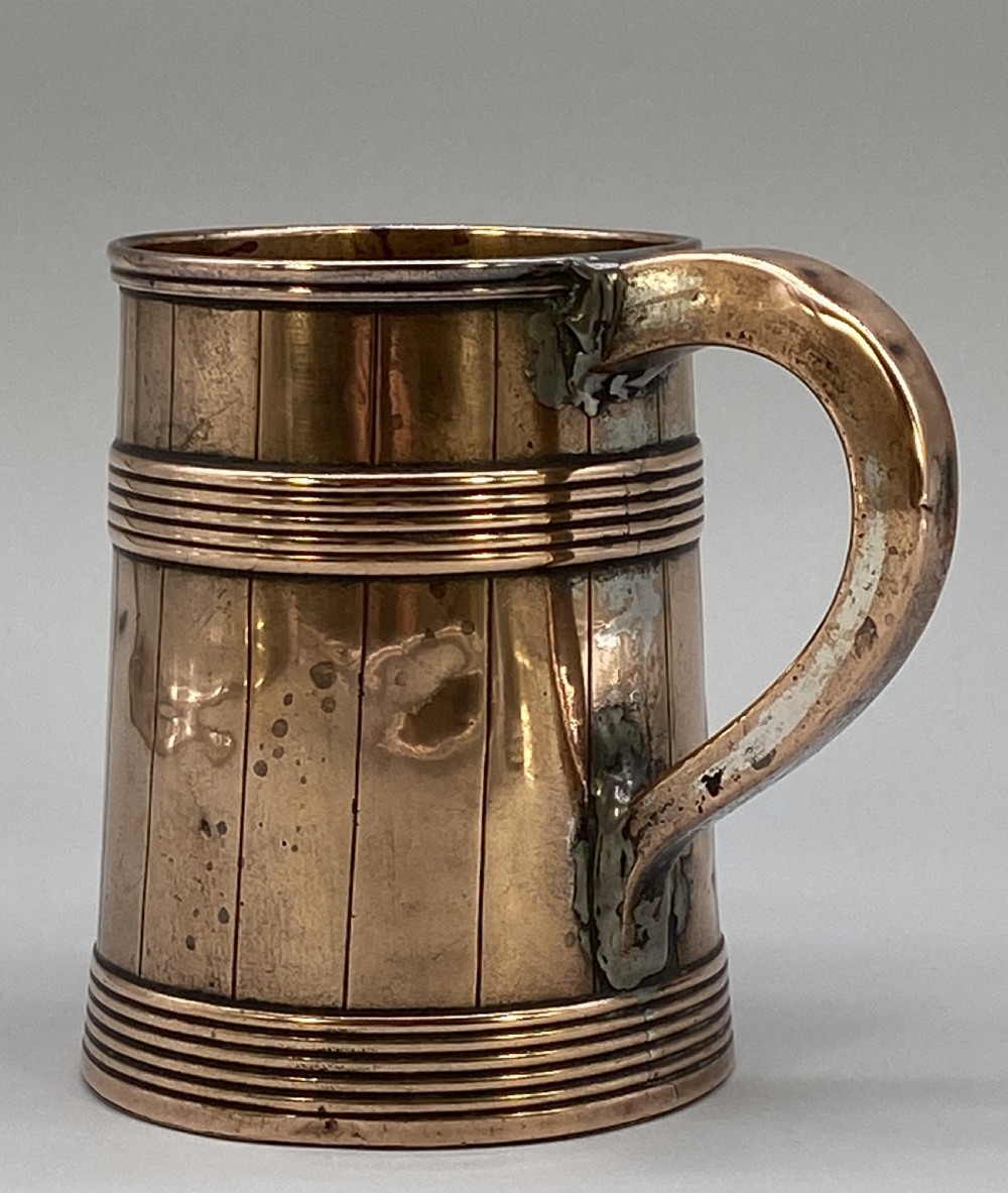 A tapered late Georgian copper tankard featuring horizontal reeded bands, vertical staved lines, and a curved nickel-plated handle. View XI