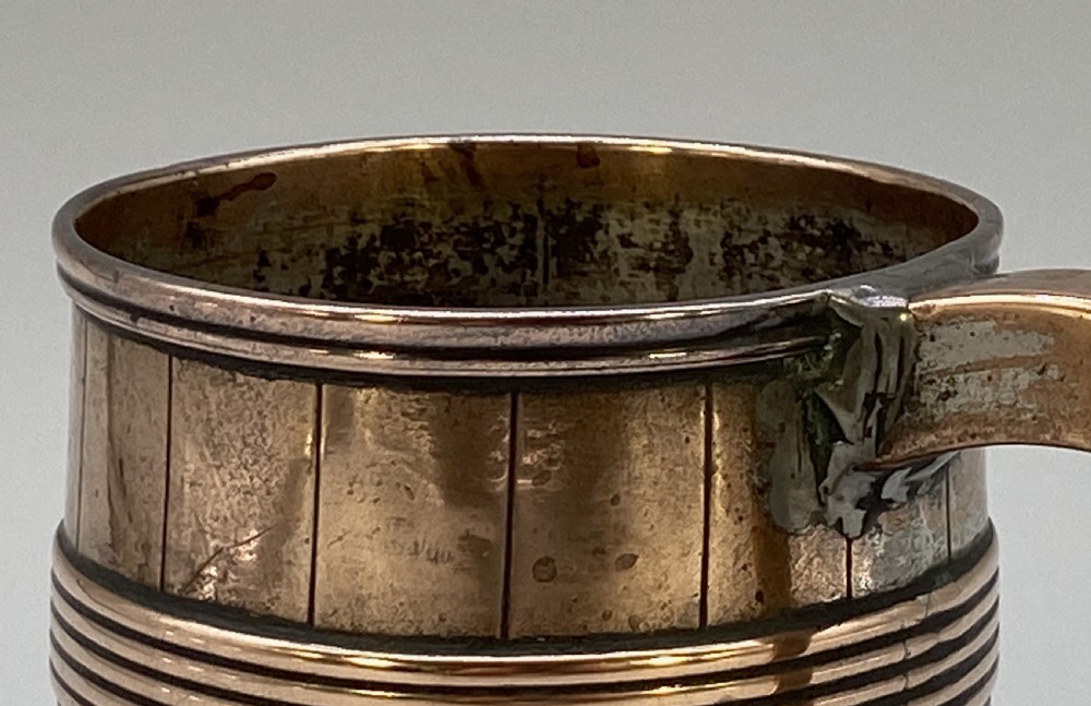 A tapered late Georgian copper tankard featuring horizontal reeded bands, vertical staved lines, and a curved nickel-plated handle. View XII