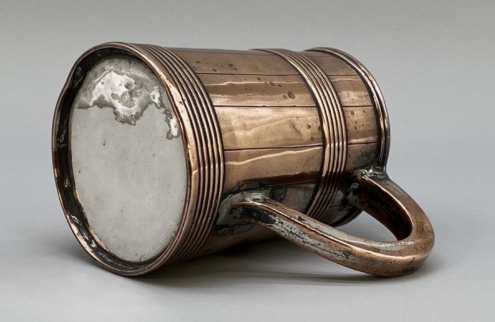 A tapered late Georgian copper tankard featuring horizontal reeded bands, vertical staved lines, and a curved nickel-plated handle. View XIV