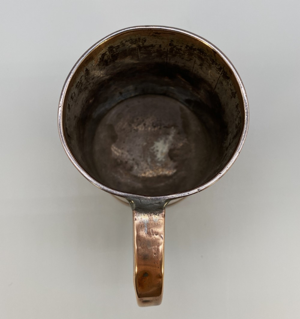 A tapered late Georgian copper tankard featuring horizontal reeded bands, vertical staved lines, and a curved nickel-plated handle. View XV