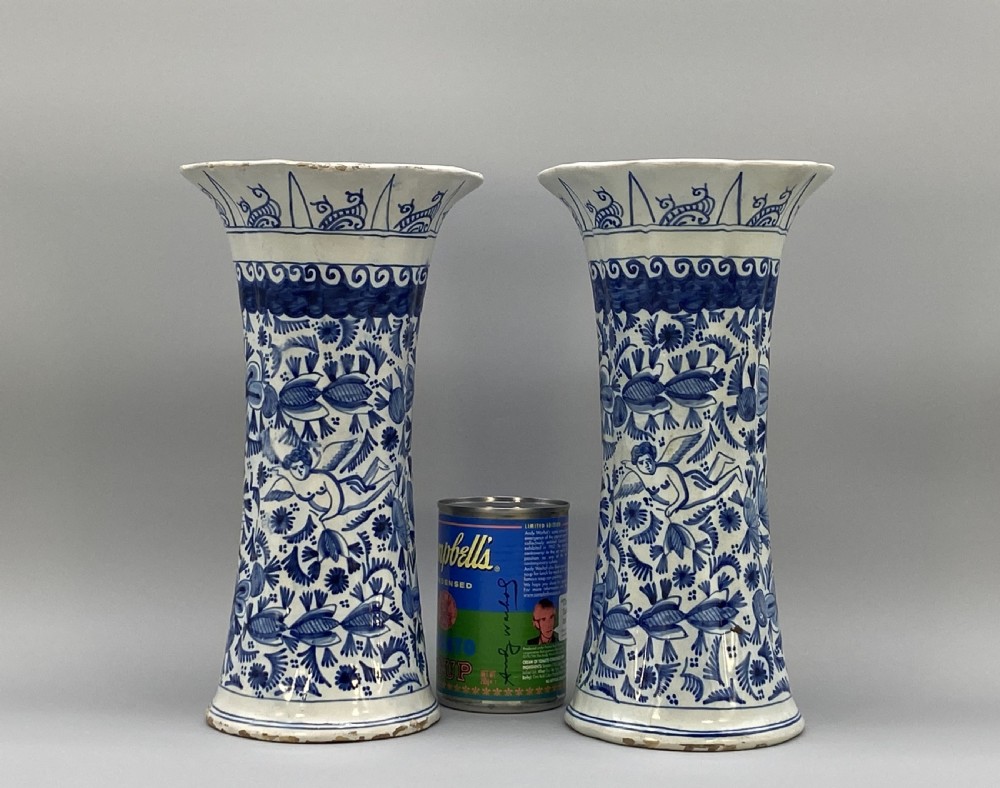 A pair of flared antique Dutch Delftware tin-glazed earthenware beaker vases decorated in cobalt blue and white with floral motifs and winged figures. View II