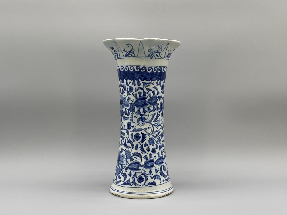 A pair of flared antique Dutch Delftware tin-glazed earthenware beaker vases decorated in cobalt blue and white with floral motifs and winged figures. View V