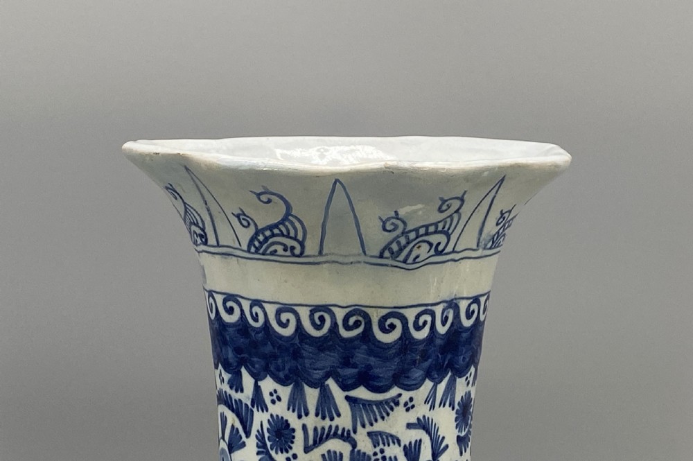 A pair of flared antique Dutch Delftware tin-glazed earthenware beaker vases decorated in cobalt blue and white with floral motifs and winged figures. View VI