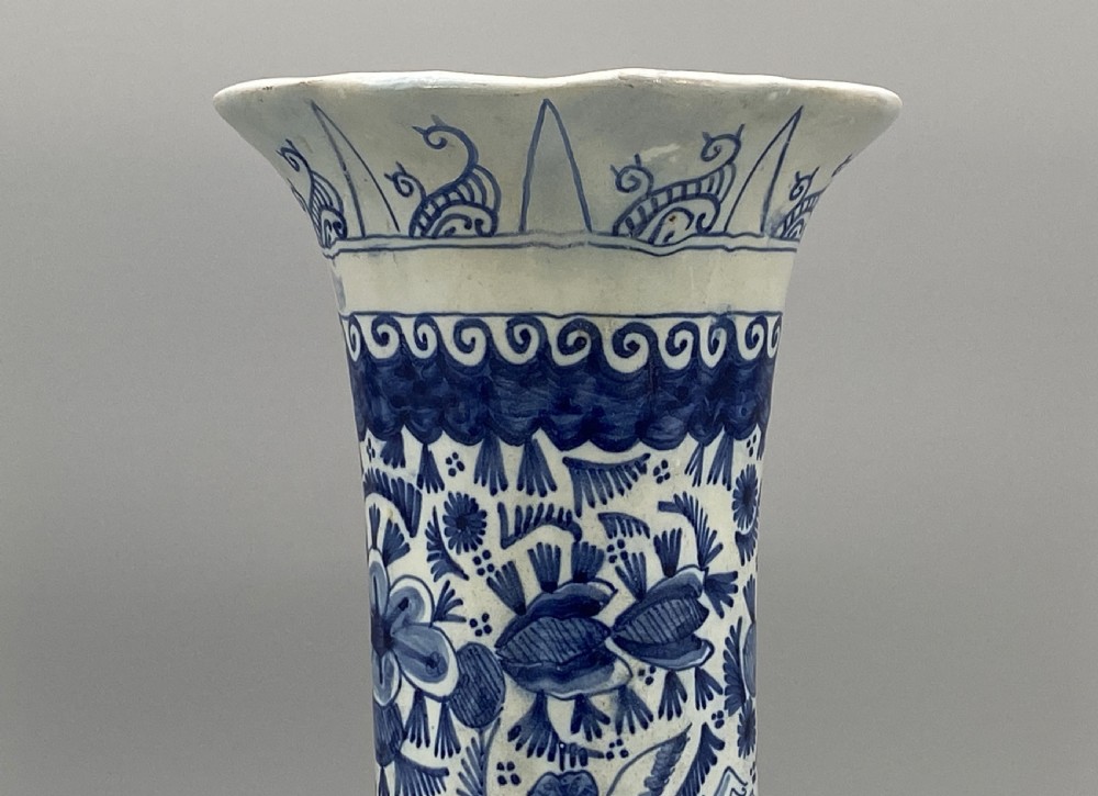A pair of flared antique Dutch Delftware tin-glazed earthenware beaker vases decorated in cobalt blue and white with floral motifs and winged figures. View VII