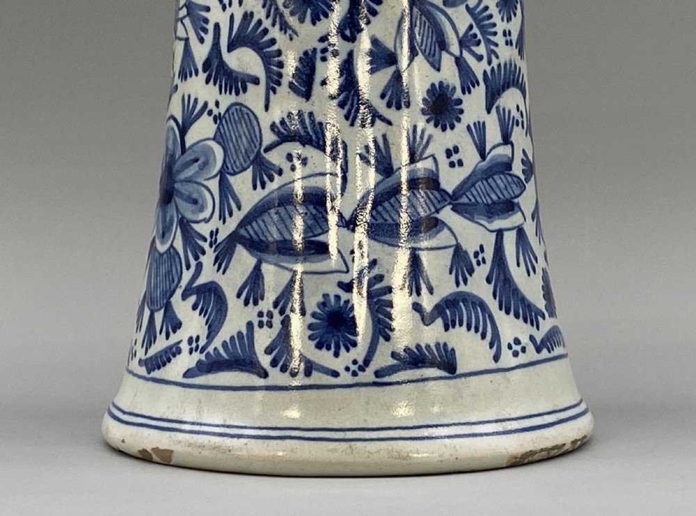 A pair of flared antique Dutch Delftware tin-glazed earthenware beaker vases decorated in cobalt blue and white with floral motifs and winged figures. View VIII