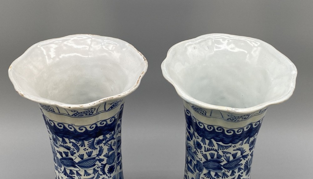 A pair of flared antique Dutch Delftware tin-glazed earthenware beaker vases decorated in cobalt blue and white with floral motifs and winged figures. View XI