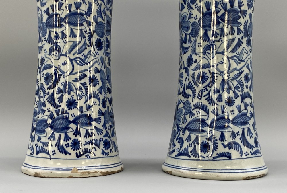 A pair of flared antique Dutch Delftware tin-glazed earthenware beaker vases decorated in cobalt blue and white with floral motifs and winged figures. View XII