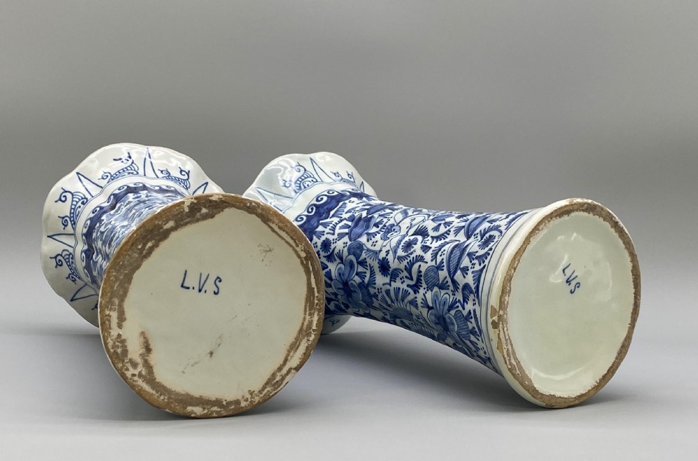 A pair of flared antique Dutch Delftware tin-glazed earthenware beaker vases decorated in cobalt blue and white with floral motifs and winged figures. View XVI