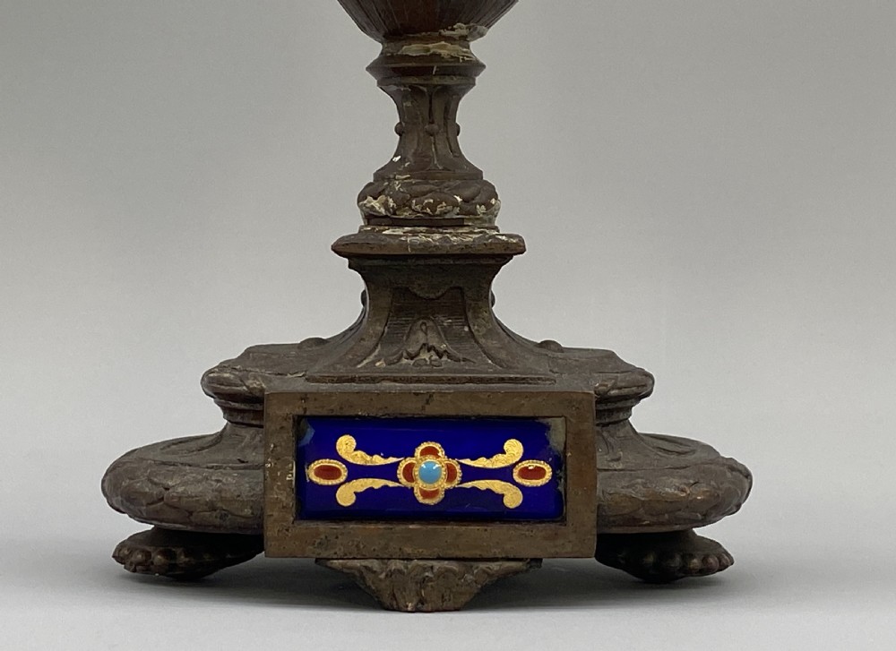 A pair of late 19th-century bronzed spelter twin-light candelabra featuring putti surmounts and urn-shaped bodies set with blue enamel plaques. View IX