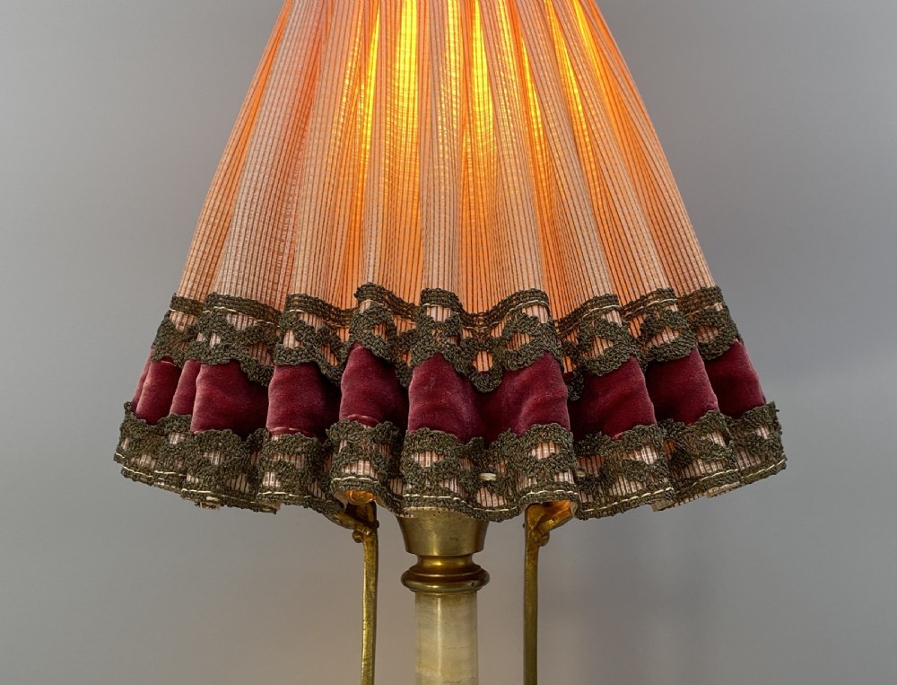 An antique French amphora-shaped white onyx table lamp with gilt metal handles and paw feet, topped with a pleated fabric shade. View VII